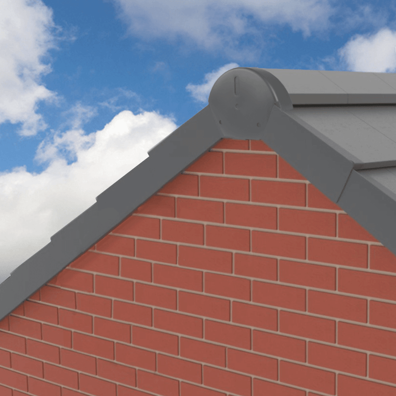 An image of a Universal dry fix half round ridge end cap in Grey fixed to the verge of a roof to show what it looks like.
