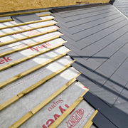 An image of Tyvek Supro Breather membrane being fitted onto a roof under the tiles and beams / lats