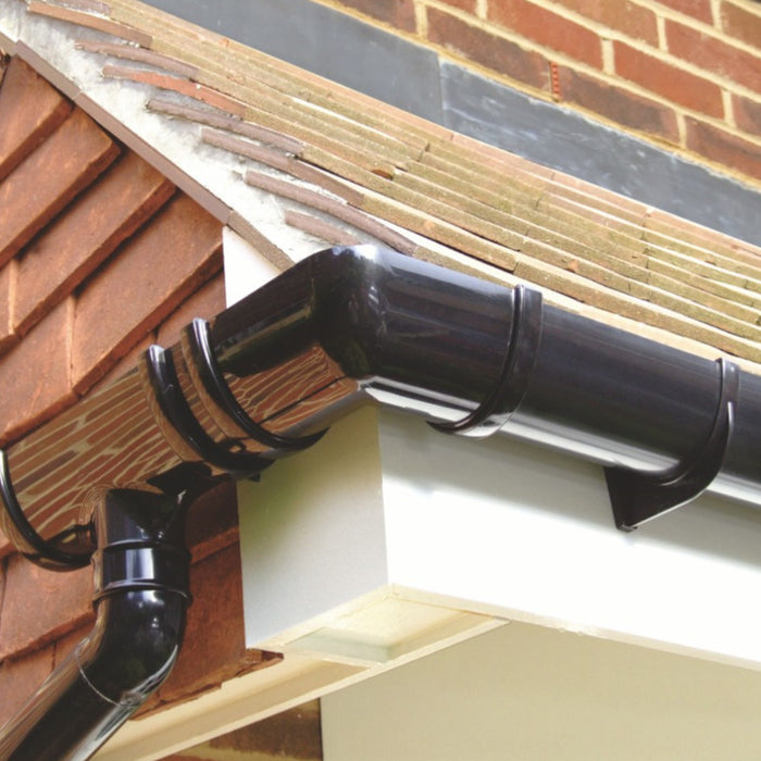 A Image of a Deep flow gutter corner in black showing the finish once its installed with several different parts.