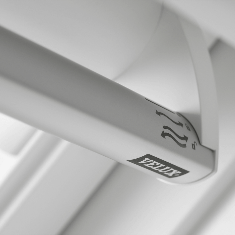 An image showing a VELUX White-Painted Centre-Pivot Window and showing the top handle where it can be operated from.