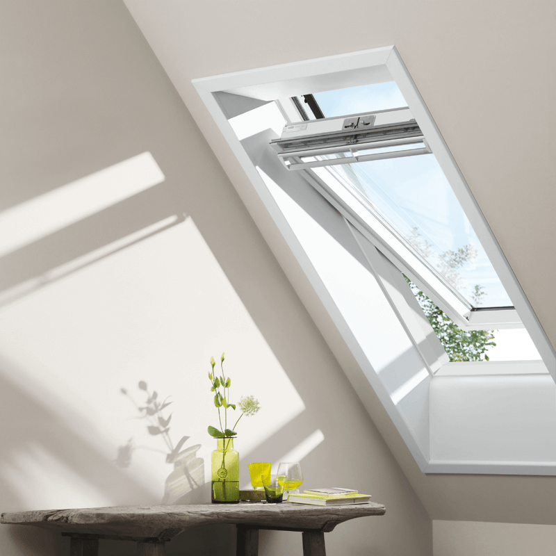 An image showing a VELUX White-Painted Centre-Pivot Window on a pitched roof