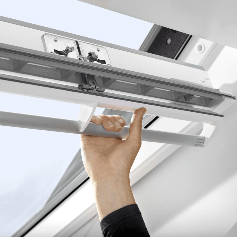 An image showing a VELUX White-Painted Centre-Pivot Window and showing the top handle where it can be operated from.
