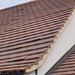 An image of a roof with the tiles being held on with verge clip