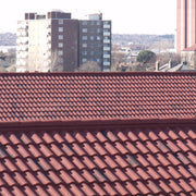 An image showing a roof with Villatile Lightweight Roofing with Ridge Closures 