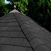 An image of Wonderbuild Square 3 Tab Shingles in Black fitted to a roof to show the finish with the tabs being used for the ridge.