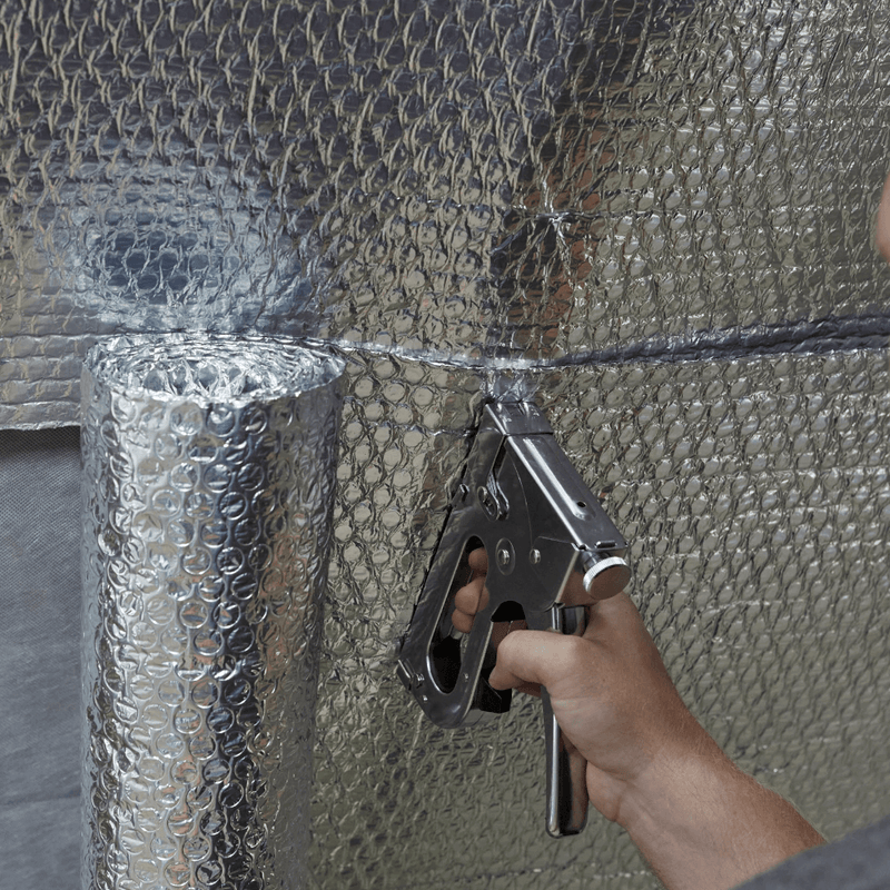 An image of YBS Airtec bubble aluminium foil insulation being staplied to a wall to show how easy it is.