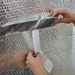 An image of YBS Airtec bubble aluminium foil insulation joins being sealed with Joining tape.