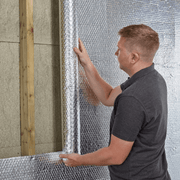 An image of YBS Airtec bubble aluminium foil insulation being applied to a wall.
