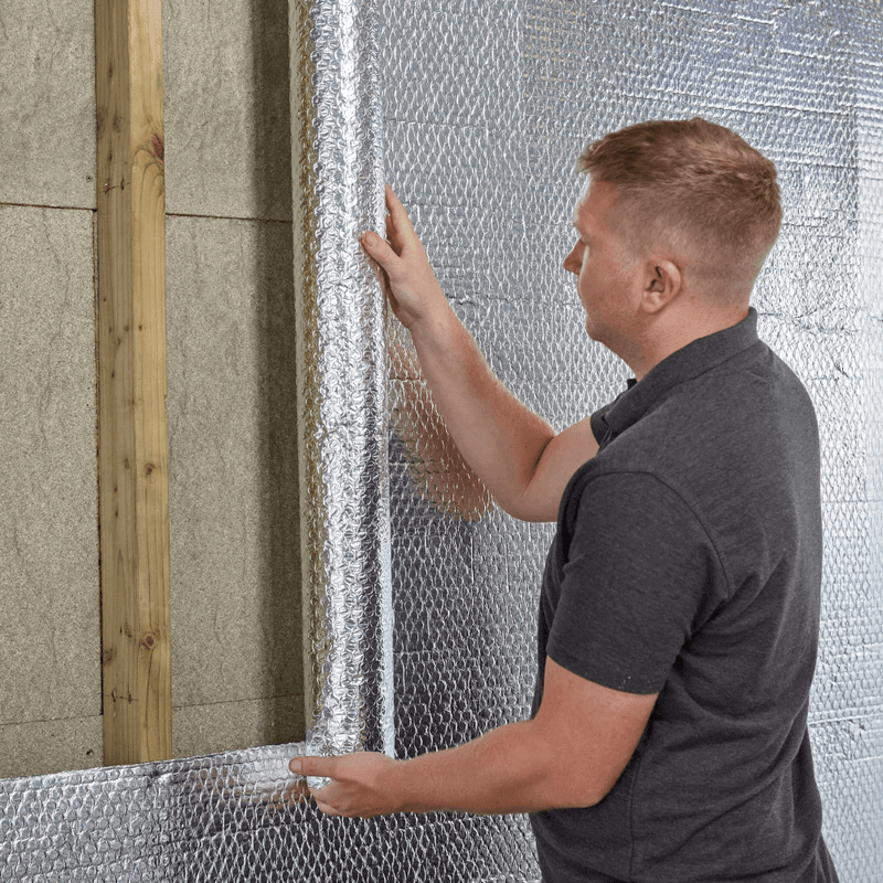 An image of YBS Airtec bubble aluminium foil insulation being applied to a wall.