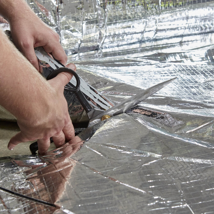 An image of ThermaQuilt Ultra being cut with a pair of Scissors