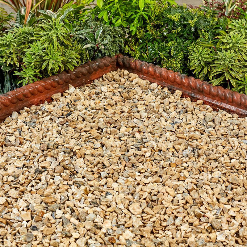 An image showing Yorkshire Cream Aggregates / stones when wet and laid in a garden.