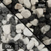 An image showing Zebra Pebble Stone Aggregate Gravel. The image is split horizontally to sow the difference between wet and dry.