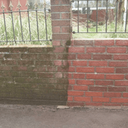 An image of a wall half treated with Azpects EASYCare Algae Remover to show how effective it is