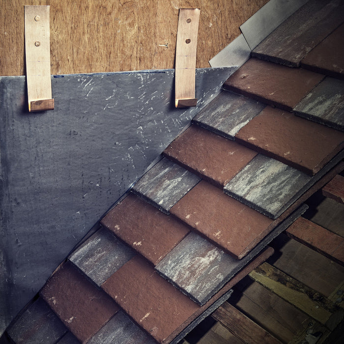 An image of a Premium Copper fixing strip bent into hooks for laying slates.