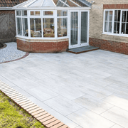 An image of Azpects easy grout porcelain paving slurry being used to fill in the gaps in paving ad how it looks when finished