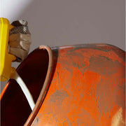 An image of Feb Febond SBR Waterproofer & Bonding Admixture being added to a cement mixer