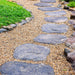 An image of Golden Flint Gravel laid out on a garden path around stepping stones