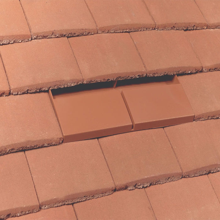 An image of a Terracotta roof with a Klober Plain Tile vent installed so show how it looks