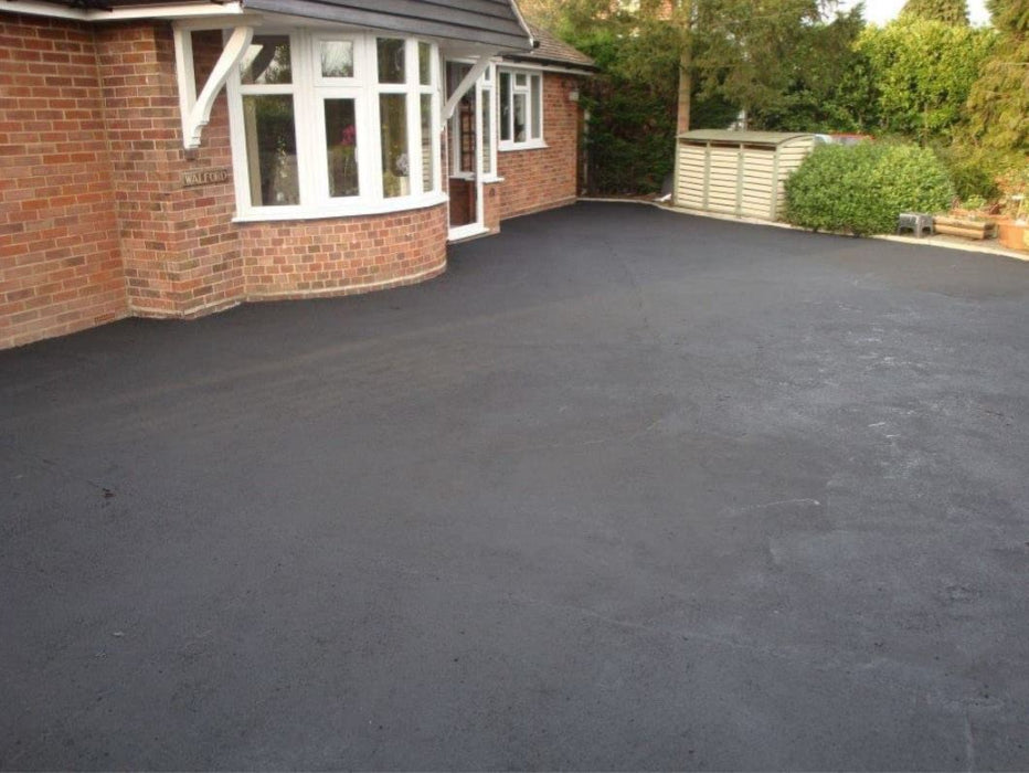 An image of the front of a house with a driveway that the product has been used on to demonstrate the use